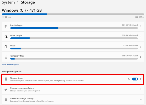 Windows Storage settings page showing disk usage breakdown (Installed apps, Other people, Other and Temporary files), with the “Storage Sense” option highlighted and turned on under Storage management.