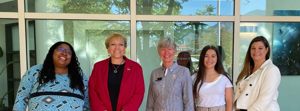 Dr. Angie Paccione and Regent Lesley Smith pose with attendees at the STEM Goes Red Event at CU Boulder