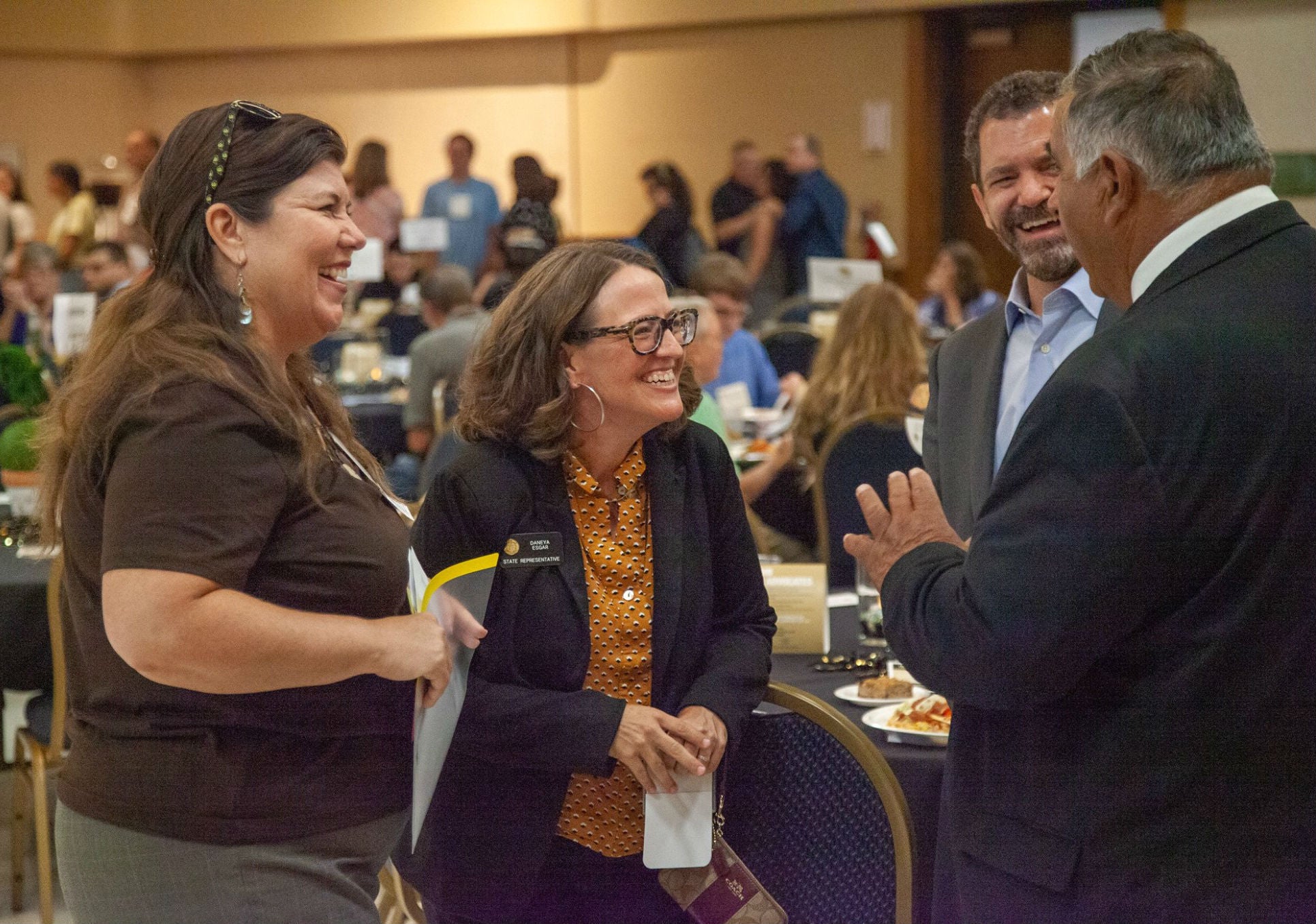 Tanya Kelly-Bowry (Vice President, Office of Government Relations), Representative Daneya Esgar (D-Pueblo) and Todd Saliman (CU Chief Financial Officer) chatting with CU Regent Glen Gallegos