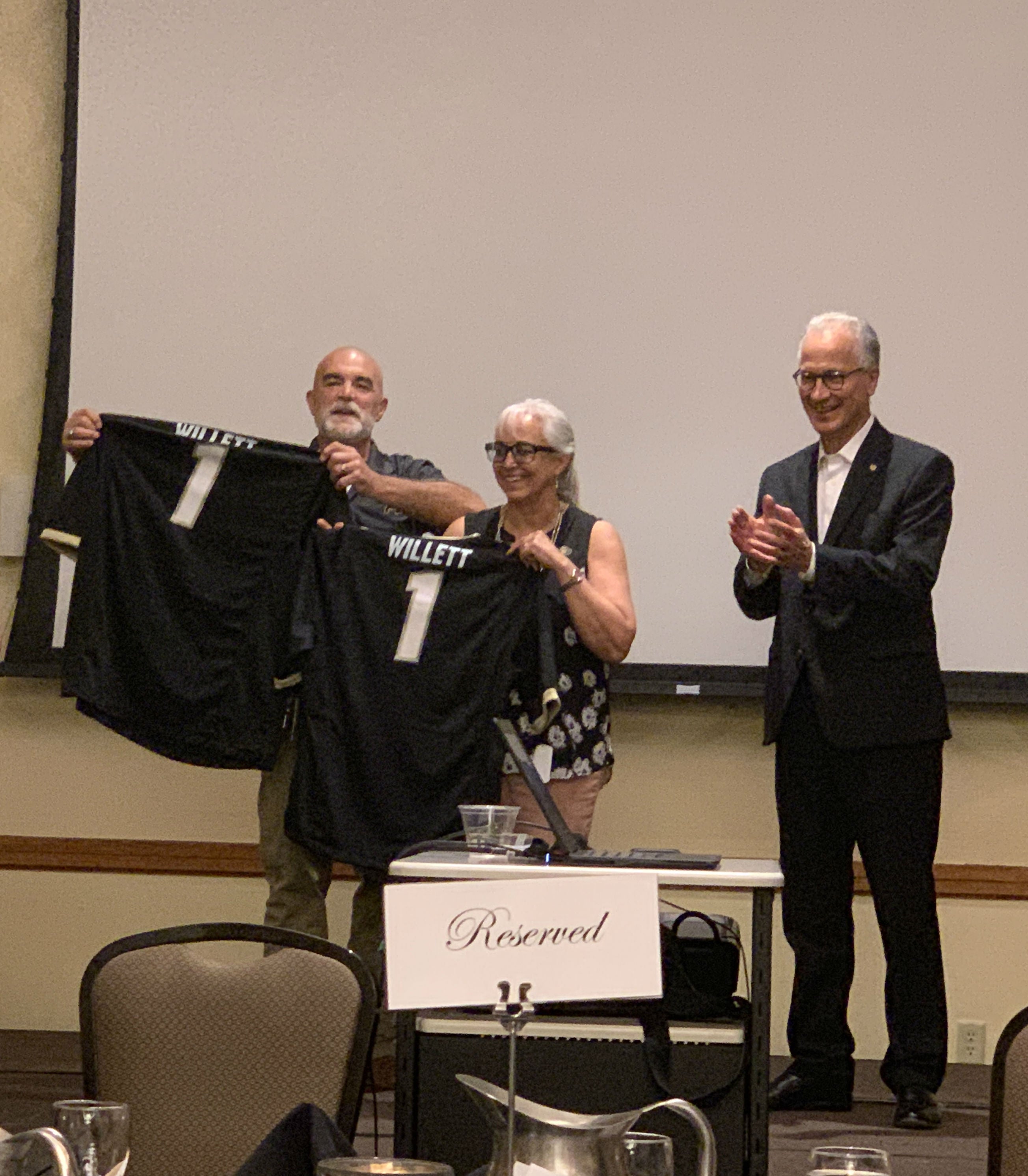 CU Regent Glen Gallegos and President Mark Kennedy presented former State Representative Yeulin Willett (R-Grand Junction) and his wife Rose with CU football jerseys at the event in Grand Junction.  