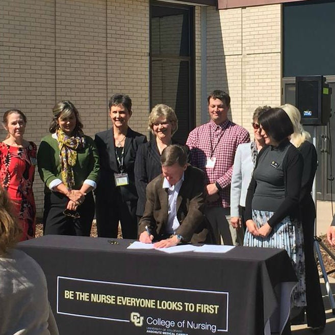 Representative Susan Lontine (D-Denver) watches as Gov. Hickenlooper Signs 