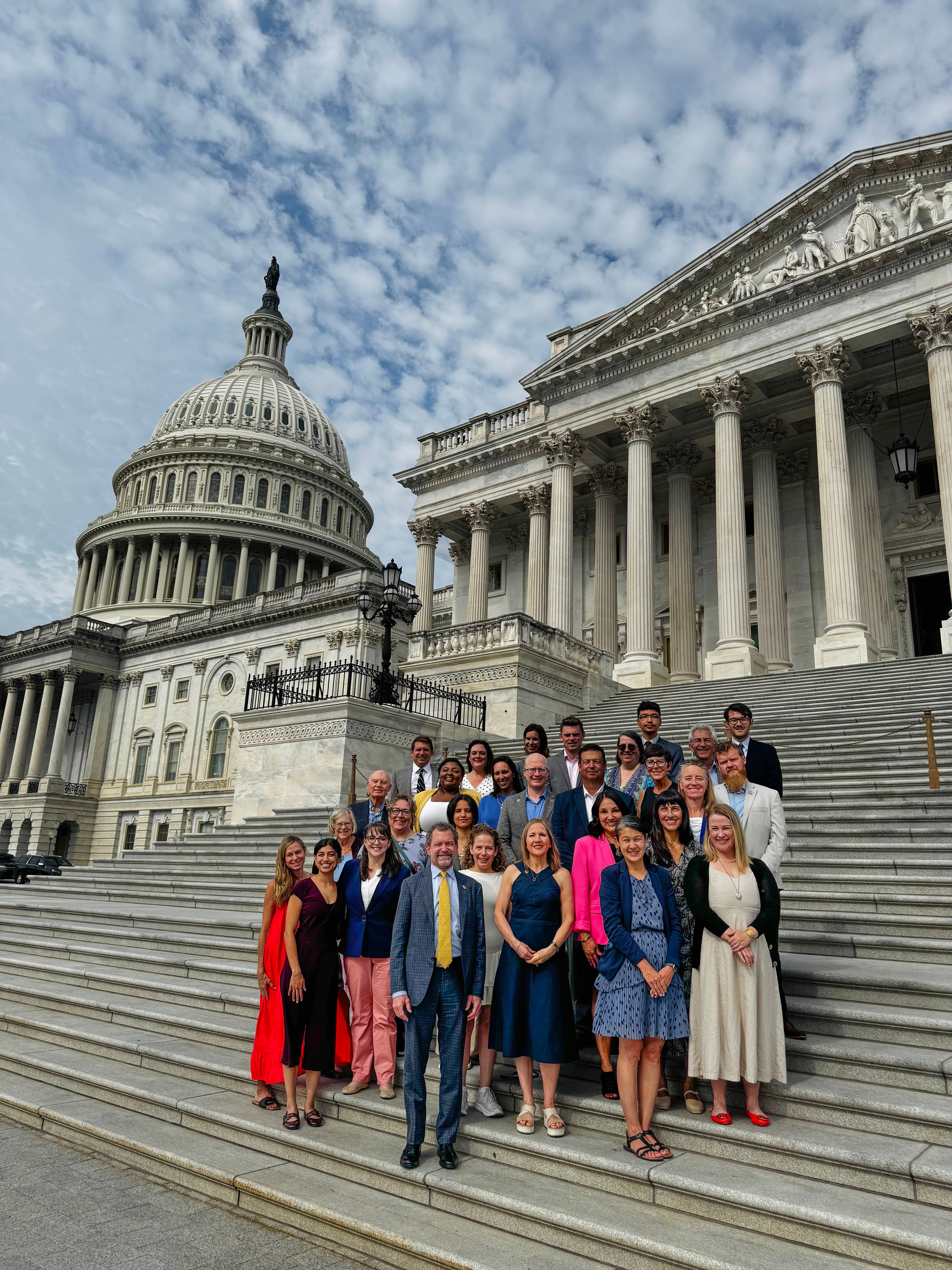 Group of CU in DC conference attendees posing on the steps of the U.S. Capitol in Washington, D.C.