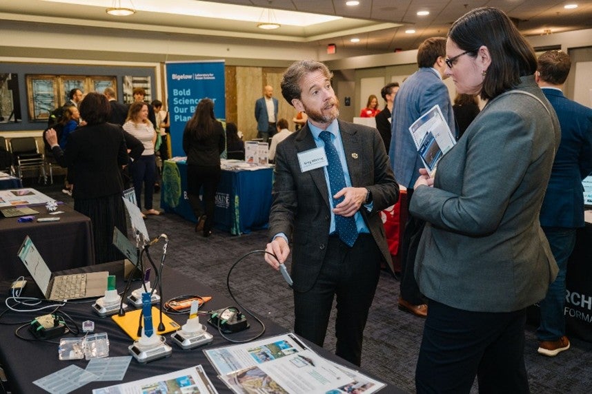 Prof. Gregory Whiting presenting reserach at a table at the Coalition for National Science Funding's congressional showcase