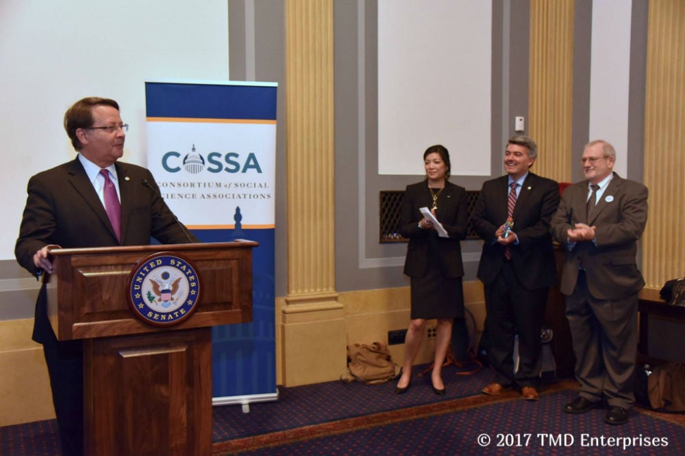 Myron Guttman presents Senator Gardner with the COSSA award.