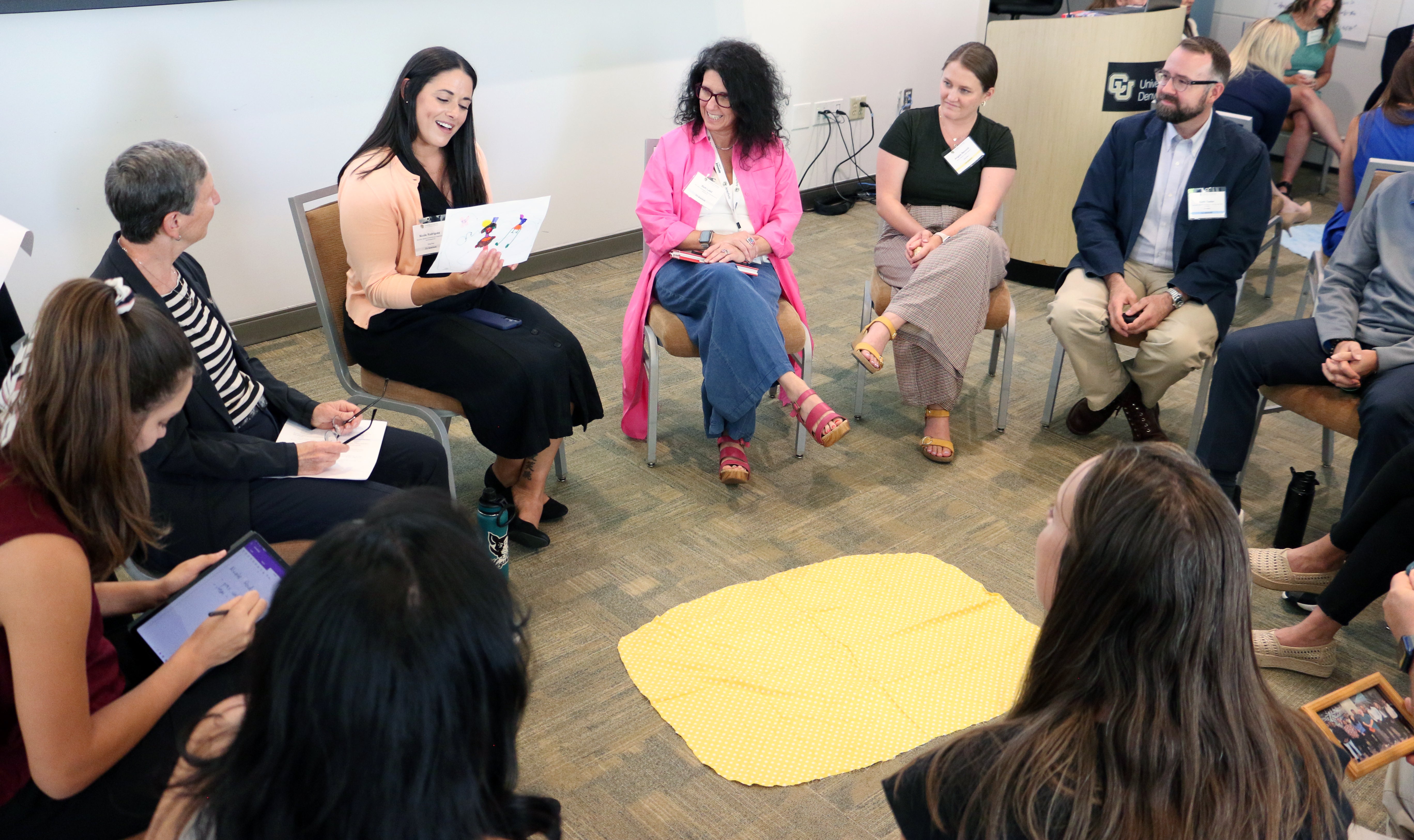 Nicole Rodriguez shares a drawing created by her daughter as part of an Excellence in Leadership Program activity where participants were asked to discuss an object that represents their leadership style. 