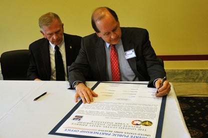 Theodore Drier (left), senior director, intelligence programs and national security solutions, Dyncorp International, and Martin Wood (right), senior vice chancellor, University Advancement 