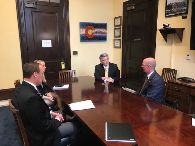 CU Athletic Director, Rick George, and CSU Athletic Director Joe Parker speak with Senator Cory Gardner in DC