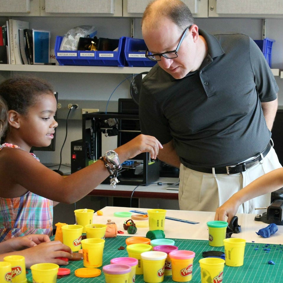 A Making Miniatures camper showing Congressman Polis her project