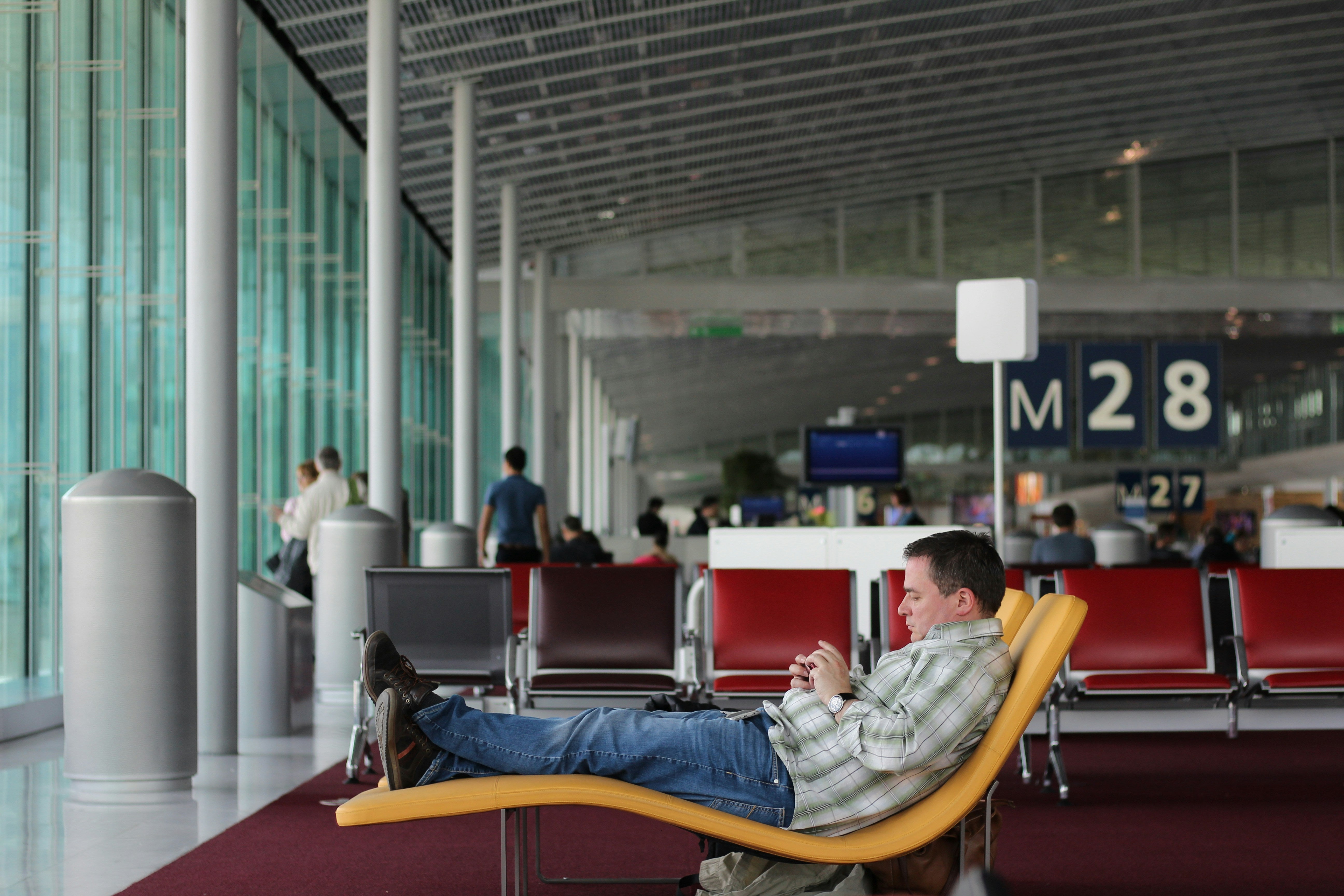 Man at Airport Using Smartphone
