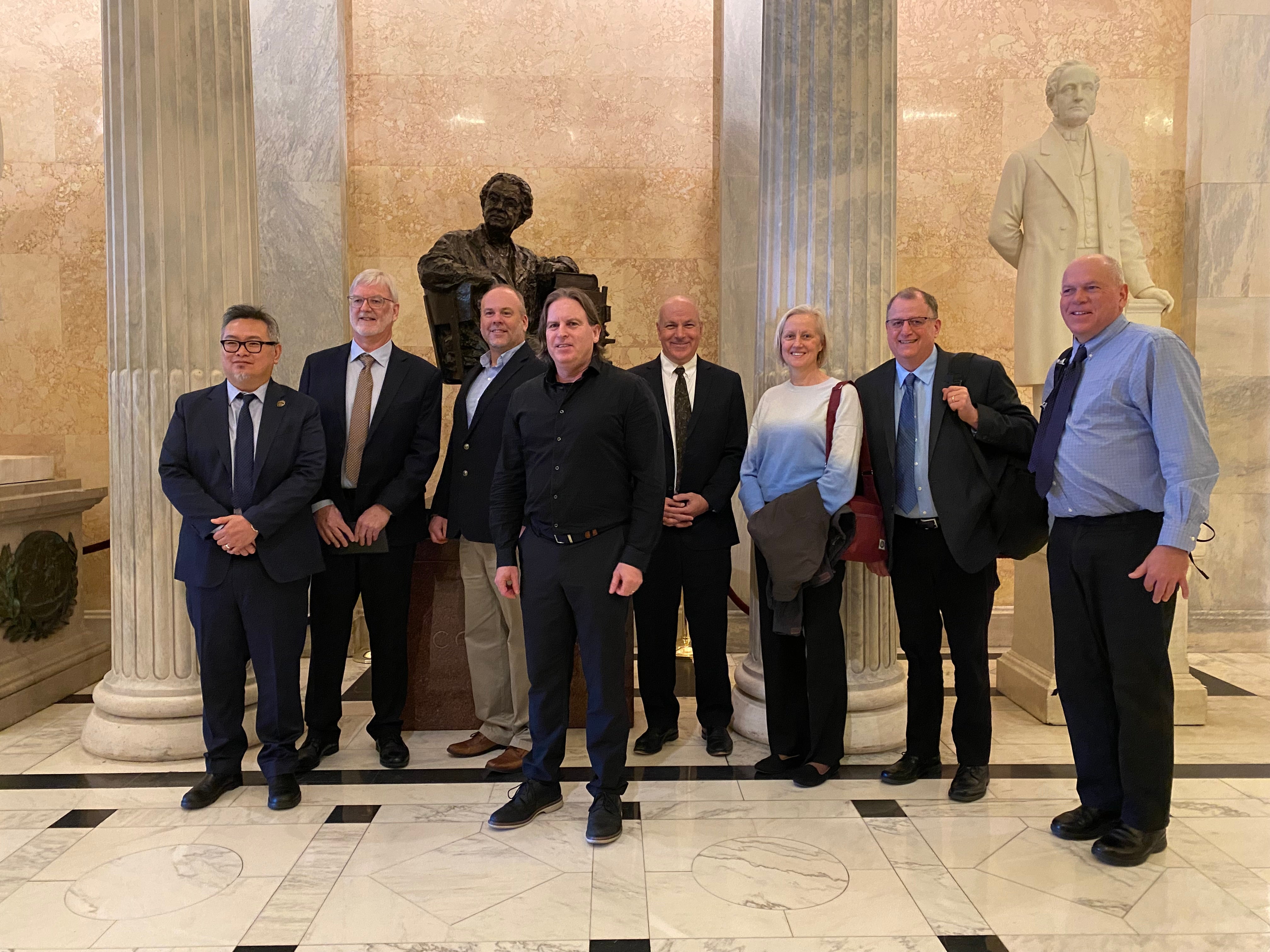 Waleed Abdalati and others at the U.S. Capitol behind a statue of Florence Sabin