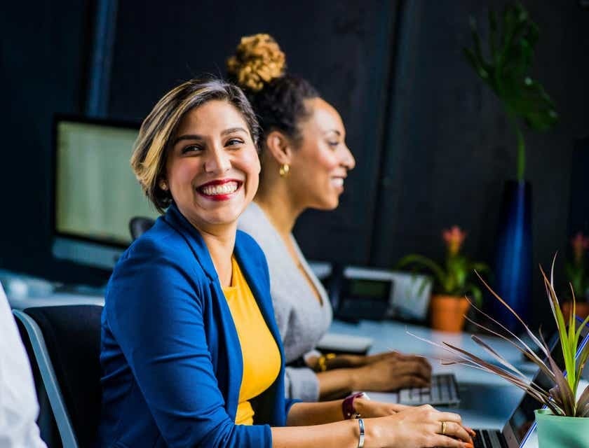 two people smiling and working 