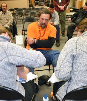 Jason chats with student volunteers as they provide treatment