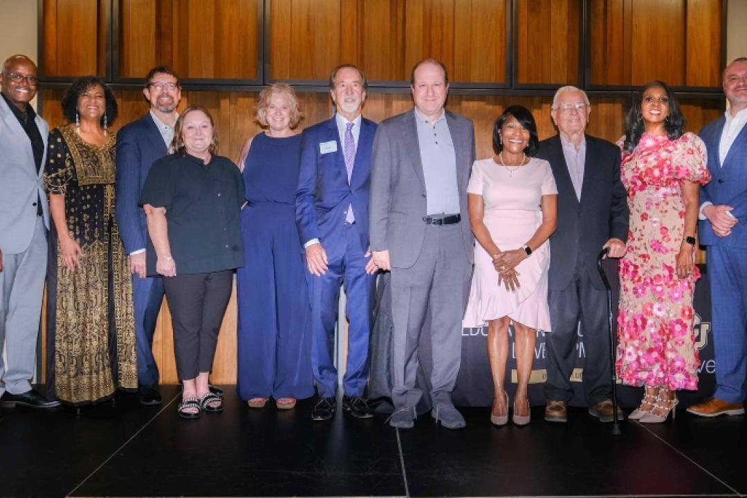 Colorado Governor Jared Polis, Former Colorado Governor Roy Romer, Chancellor Kenneth Christensen, Dean Marvin Lynn, Dr. Lisa Roy, Reed Martin, and 2025 SEHD Alumni Leadership Award recipients