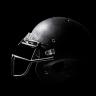 Black and white photo of a football helmet on a black background