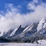 Photo of the flatirons above Boulder, Colorado covered in snow.