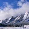 Photo of the flatirons above Boulder, Colorado covered in snow.