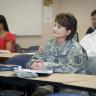 Photo of student soldier from UCCS sitting at a table in a classroom.