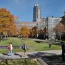 Photo of CU Denver Campus in the fall with a few students walking by in the foreground.