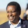 Congressman Joe Neguse smiling in a dark blue suit