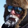 Konrad Steffen outside in the snow with sunglasses and ice on his beard