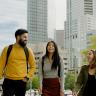 Photo of three people talking and laughing while walking in downtown Denver.