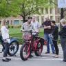 Campus community members gather around electric bikes during the 2018 Alternative Fuel Vehicle Ride-n-Drive event